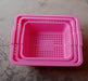 Plastic baskets for fruit, displayed neatly in a kitchen setting.