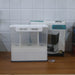 The 3-in-1 wall-mounted cereal dispenser in action, dispensing lentils.