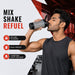 A man in a black tank top drinks from a grey and black shaker bottle in a gym, with text "MIX SHAKE REFUEL" and feature