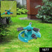 A teal and black garden sprinkler sits on a lawn with a smaller inset image of it in use.