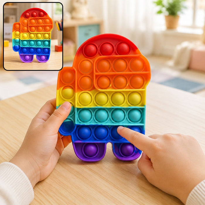 A child's hands press the bubbles of a rainbow Among Us character pop-it fidget toy on a wooden table.