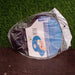 The black ergonomic mouse pad is packaged in clear plastic with a blue label, on a green and brown surface.